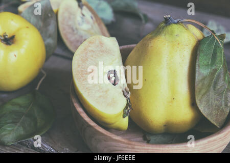 Fresh quince fruit on dark wooden table Stock Photo