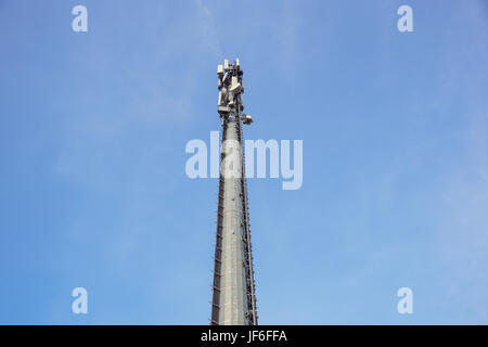 Communication Tower with antennas such a Mobile phone tower, Cellphone Tower, Phone Pole on the blue sky background. Stock Photo