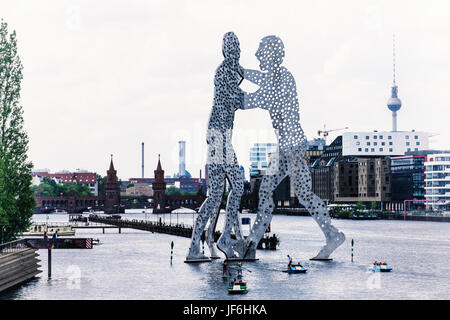 Berlin,Friedrichshain,River Spree.Molecule Man,aluminium sculpture by American artist Jonathan Borofsky- Three giant men pierced with holes Stock Photo
