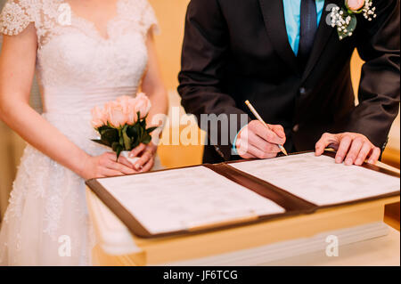 Wedding ceremony. Wedding couple leaving their signatures Stock Photo