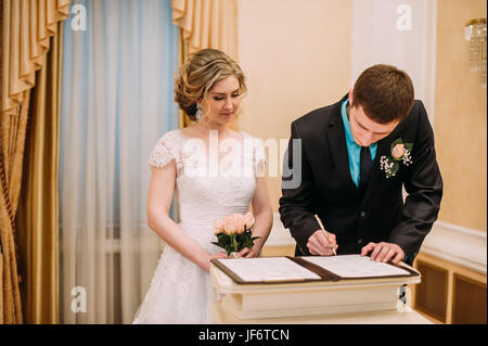 Wedding ceremony. Wedding couple leaving their signatures Stock Photo