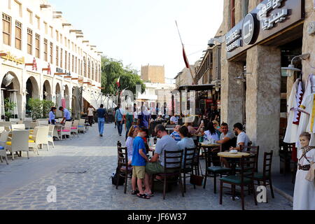 DOHA, QATAR - APRIL 9, 2017: Tourists relax at one of many cafes in Souq Waqif market in Doha. Stock Photo