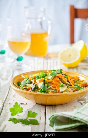 Plate of pasta with some grilled zucchini and carrots with herbs Stock Photo