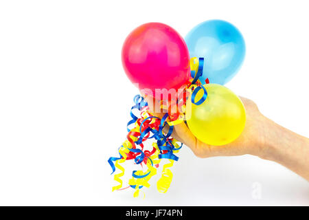 Hand giving colorful balloons with ribbons Stock Photo