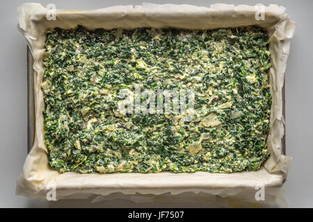 Raw Greek pie Spanakopita top view Stock Photo