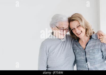 Portrait of senior woman holding hands with daughter Stock Photo