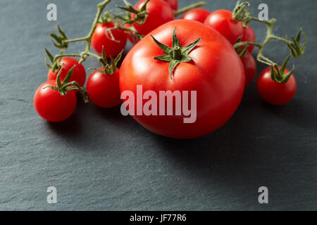 Cherry Tomatoes on Black Stone Stock Photo
