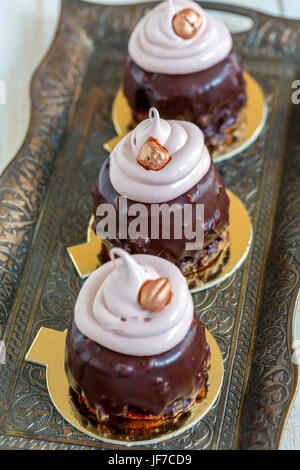 Cupcakes with chocolate frosting and walnuts. Stock Photo