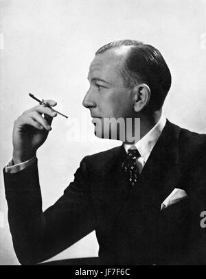 Noel Coward profile smoking with a cigarette holder, circa 1936. English actor, playwright & composer: 16 December 1899 – 26 March 1973. Stock Photo
