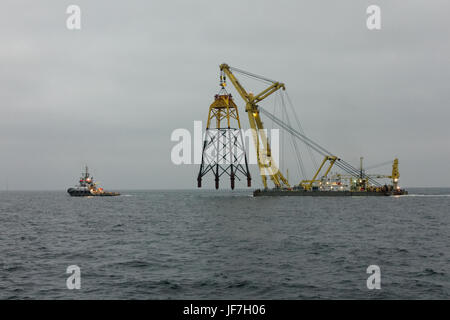 The Floating Shear Leg Crane Vessel TAKLIFT 4 transporting a platform for the Wikinger Offshore Windfarm in the Baltic Sea. Stock Photo