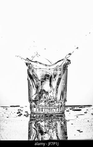ice cube dropped into the water with splash Stock Photo - Alamy