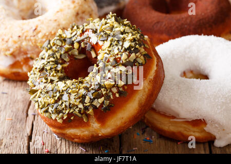 Beautiful donuts with sunflower seeds and coconut close-up on the table. horizontal Stock Photo