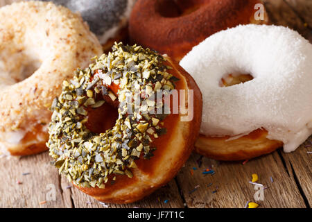 Freshly baked donuts with sunflower seeds and coconut close-up on the table. horizontal Stock Photo