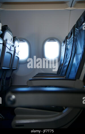 FRANKFURT, GERMANY - JAN 20th, 2017: Airplane business class seat and window inside an Lufthansa Airbus A320 aircraft with view of clouds Stock Photo