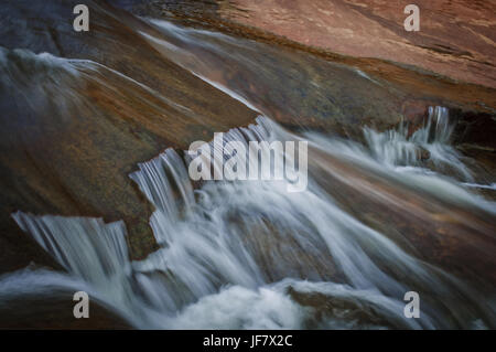 Fresh water flowing over rocks on a creek. Stock Photo