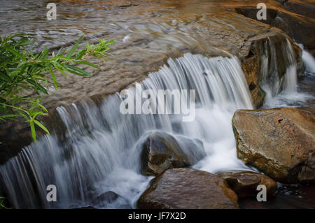 Fresh water flowing over rocks on a creek. Stock Photo