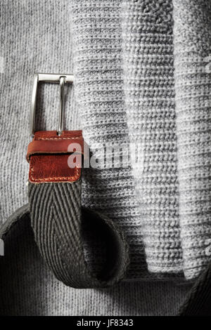 Black leather belt on background knit fabric Stock Photo