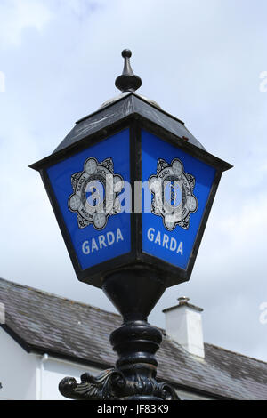 A blue lantern bearing the title and insignia of the Irish police service - the Garda Siochana. Stock Photo