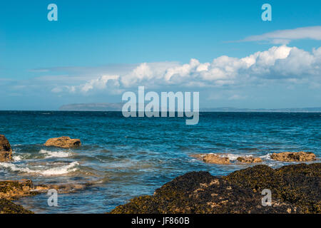 Beautiful seascape depicting North Wales coastal features, (Moel Wnion, Foel Ganol, Cefn Maen Amor, Conway Peninsula) on summers day with blue skies. Stock Photo