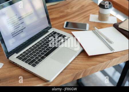 Notebook and laptop computer on able in office. Portable and mobile devices for freelance worker. Anywhere online working concept. Stock Photo