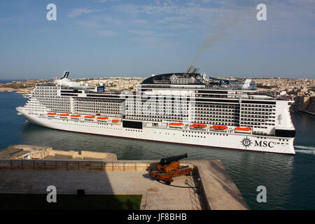 Mediterranean travel. The huge modern cruise ship or liner MSC Meraviglia departing from Malta, as seen from the Upper Barrakka in Valletta Stock Photo