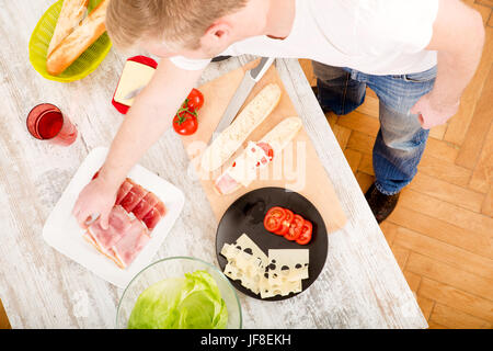 Young man preparing a Sandwich Stock Photo
