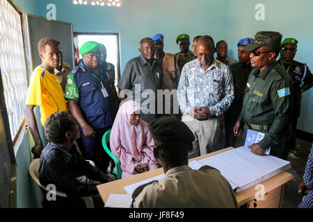 Dr. Opiyo Ododo (left), the head of stabilisation and early recovery of the African Union Mission in Somalia (AMISOM), Ahmed Nasir, the Jubbaland Police commissioner, and the African Union Mission in Somalia (AMISOM) Police Training Coordinator, Assistant Commissioner of Police (ACP) Francis Ayitey Aryee, attend the handover of the newly renovated police station to Jubbaland Administration on May 8, 2017. AMISOM Photo Stock Photo