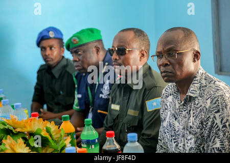 Dr. Opiyo Ododo (left), the head of stabilisation and early recovery of the African Union Mission in Somalia (AMISOM), Ahmed Nasir, the Jubbaland Police commissioner, and   The African Union Mission in Somalia (AMISOM) Police Training Coordinator, Assistant Commissioner of Police (ACP) Francis Ayitey Aryee, attend the handover of the newly renovated police station to Jubbaland Administration on May 8, 2017. AMISOM Photo Stock Photo