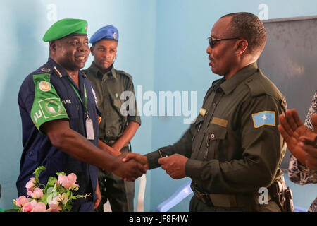 The African Union Mission in Somalia (AMISOM) Police Training Coordinator, Assistant Commissioner of Police (ACP) Francis Ayitey Aryee, greets Ahmed Nasir, the Jubbaland Police commissioner, at a ceremony to officially hand over the newly renovated police station to Jubbaland Administration on May 8, 2017. AMISOM Photo Stock Photo