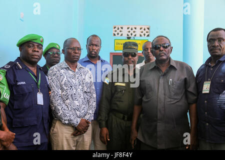 Dr. Opiyo Ododo (left), the head of stabilisation and early recovery of the African Union Mission in Somalia (AMISOM), Ahmed Nasir, the Jubbaland Police commissioner, and   The African Union Mission in Somalia (AMISOM) Police Training Coordinator, Assistant Commissioner of Police (ACP) Francis Ayitey Aryee, attend the handover of the newly renovated police station to Jubbaland Administration on May 8, 2017. AMISOM Photo Stock Photo