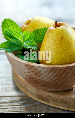 Ripe pear and a sprig of mint. Stock Photo