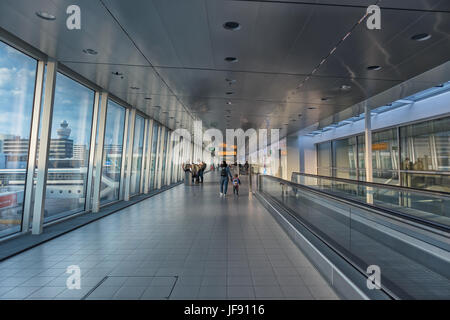 Airport corridor with people walking in schiphol. Stock Photo