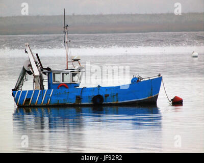 A blue fishing boat / trawler moored near Harty Ferry on the Swale in Kent. Stock Photo