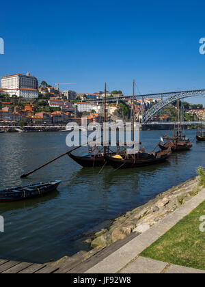 Old style wooden boats (Rabelos) moored on the river Douro by Cais de Gaia overlooking the historic part of Porto, Portugal Stock Photo