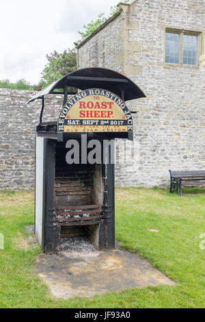 Revolving Roasting Jack in the historic village of Eyam in the Derbyshire Peak District where a sheep is spit roast Stock Photo