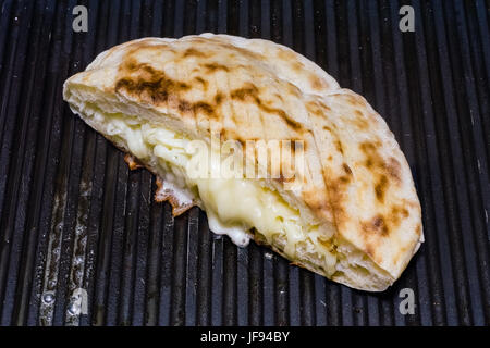 Closeup of Turkish toast (Tost), toasted sandwich with cheddar cheese in a oily grill Stock Photo