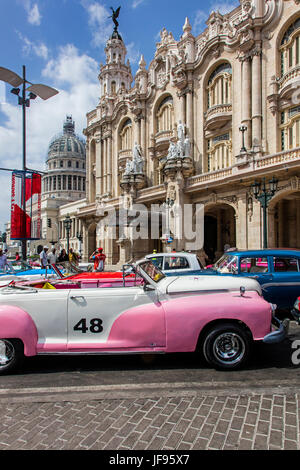 AMERICAN CARS are used as taxis in front of of the GRAND TEATRO DE HABANA - HAVANA, CUBA Stock Photo