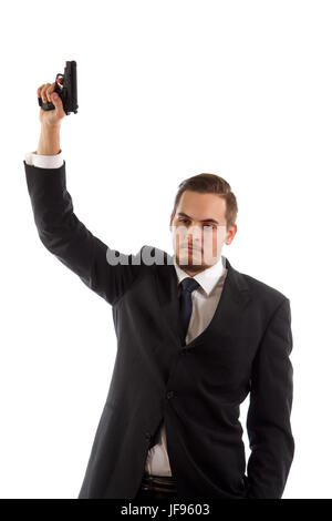 A man in a suit holding a gun in the air Stock Photo