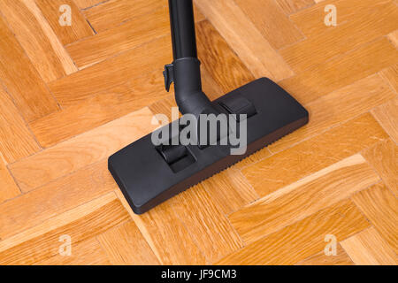 Vacuum cleaner on parquet Stock Photo