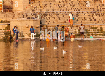 Men and women at a ghat in Varanasi, India on the shores of the Ganges river. Uttar Pradesh. Stock Photo