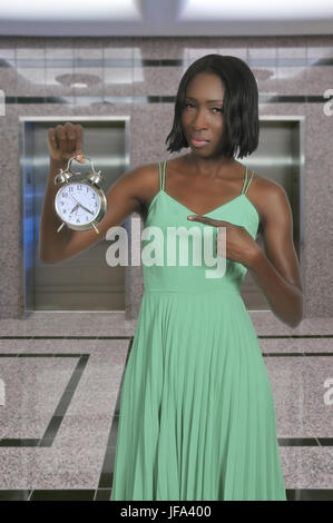 Woman with alarm clock Stock Photo