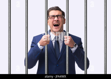 Young businessman behind the bars in prison Stock Photo