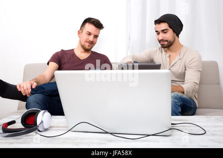 Two young men using a tablet pc Stock Photo