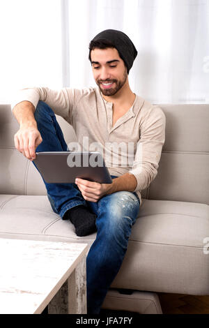 Young man using a tablet pc Stock Photo