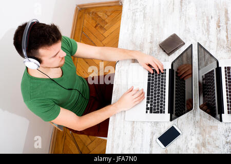 Young man typing on his laptop Stock Photo