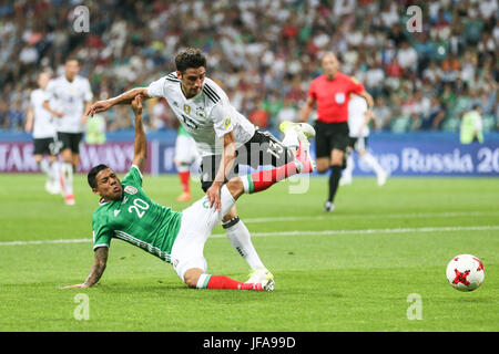 Sochi, Russia. 29th June, 2017. Lars Stindl (front R) of Germany shoots facing the slide tackle of Mexico's Javier Aquino during the semifinal match of the 2017 FIFA Confederations Cup in Sochi, Russia, June 29, 2017. Germany won 4-1. Credit: Wu Zhuang/Xinhua/Alamy Live News Stock Photo