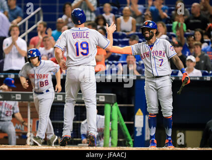 Miami Marlins Jose Reyes motions his team mates after sliding into second  base against the New York Yankees at the new Miami Marlins Ball Park in the  second exhibition game April 2