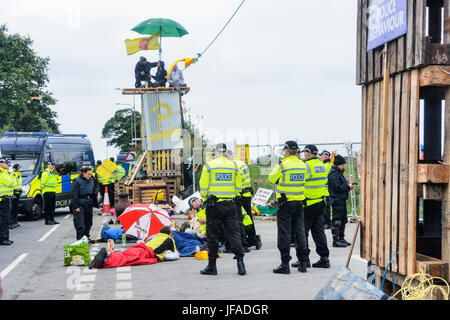 Blackpool, UK. 30th June, 2017. Cuadrilla's shale gas fracking site at Little Plumpton, Blackpool was targeted by anti-fracking protesters who built two towers, made from wooden palettes, overnight along with four protesters who locked themselves together in front of the site entrance using steel tubes. Around 100 anti-fracking protesters were in attendance along Preston New Road in the vicinity of the site. Credit: Dave Ellison/Alamy Live News Stock Photo