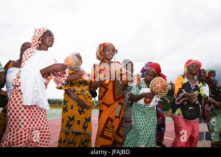 (170630) -- SOUBRE (COTE D'IVOIRE), June 30, 2017 (Xinhua) -- Local residents dance to celebrate the initiation of electricity generation of the Soubre hydroelectric power station near the city of Soubre in Cote d'Ivoire, on June 30, 2017. A ceremony was held Friday in Cote d'Ivoire to officially mark the initiation of electricity generation at Soubre hydroelectric power station, which was built by a Chinese company. With an installed capacity of 275 MW, the 4.5-km-long Soubre dam is the largest of its kind so far in the western African country. (Xinhua/Pan Siwei) Stock Photo
