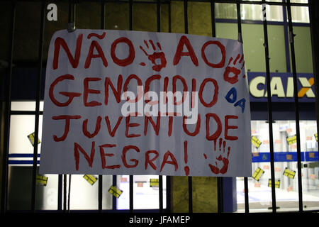 Rio de Janeiro, Brazil, June 30, 2017: Plate with sayings 'No to the genocide of black youth'. Brazilian workers carried out a general strike in the main cities of the country. In Rio de Janeiro, during the night, a demonstration gathered thousands of people protesting against the government of President Michel Temer and also against the labor and pension reforms that Brazil is going through. At the end of the protest, police and demonstrators clashed and a man who identified himself as a police officer was injured. A photographer had his equipment damaged. Credit: Luiz Souza/Alamy Live News Stock Photo